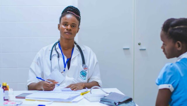 doctor sitting at the table in front of girl