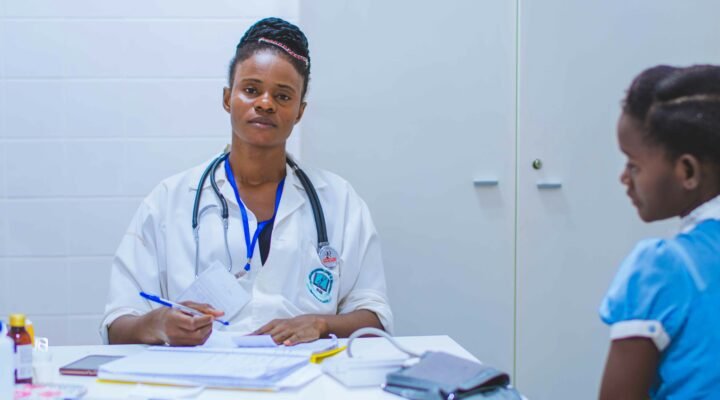 doctor sitting at the table in front of girl