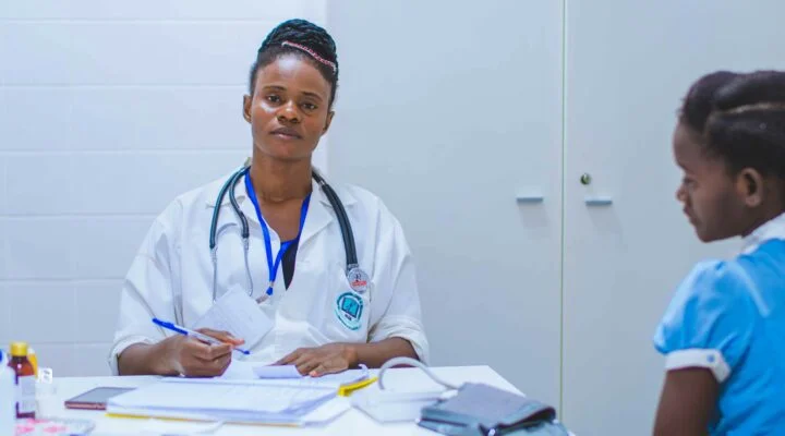 doctor sitting at the table in front of girl