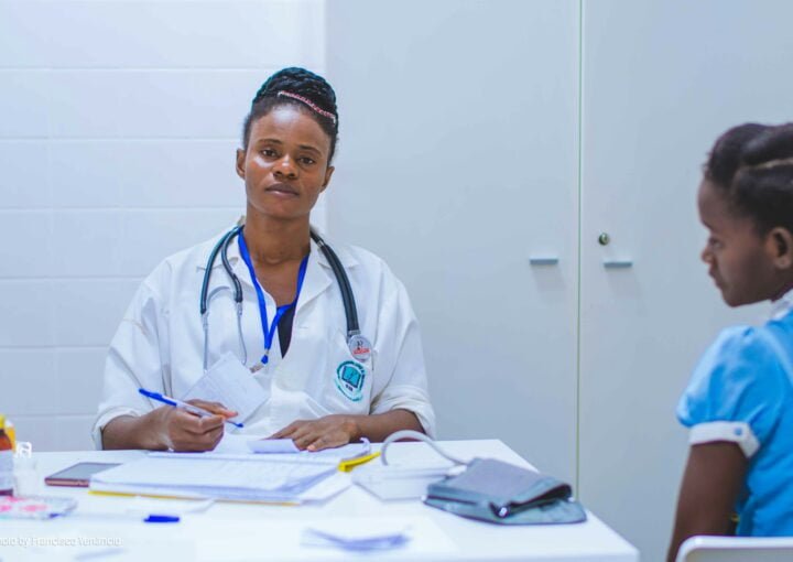 doctor sitting at the table in front of girl